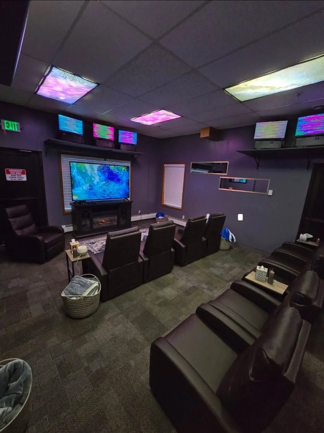 The Energy Enhancement Room with reclining chairs facing a large screen