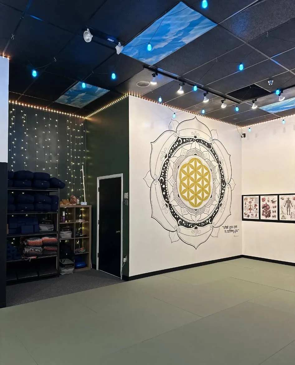 Studio room with a painted mandala and flower of life on the wall